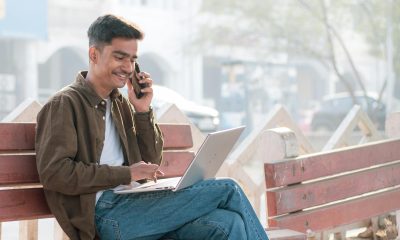 Candidate checking RRB admit card on laptop