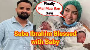 Saba and Sunny holding their baby boy