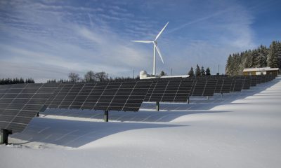 Adani Group renewable energy projects in 2025 with solar farms and wind turbines.