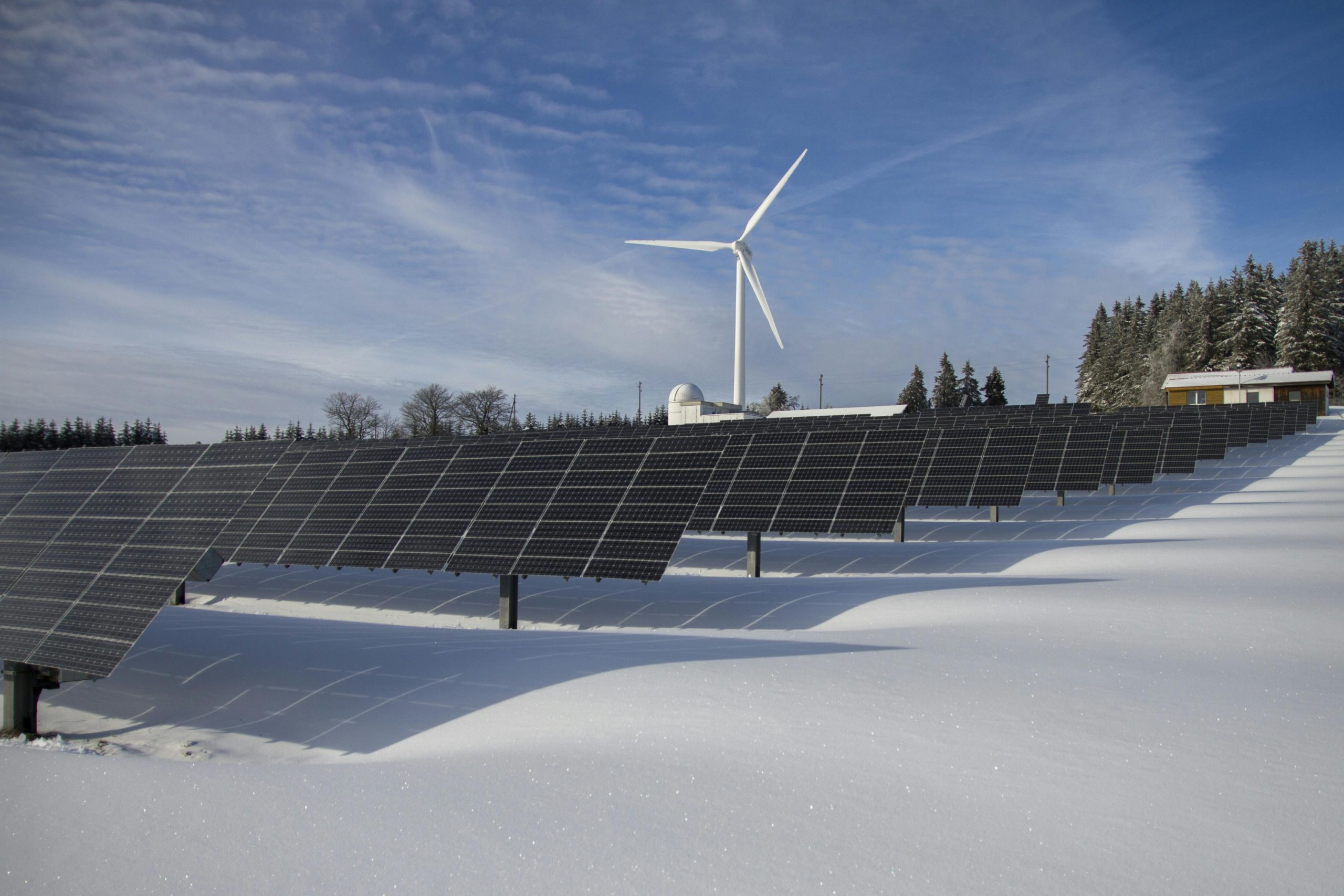 Adani Group renewable energy projects in 2025 with solar farms and wind turbines.